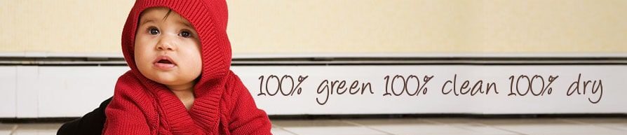 Baby in red sweater crawling on a tiled floor near a green product sign.