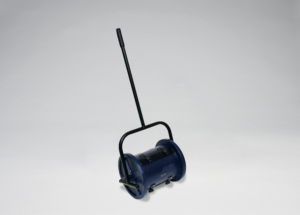 A blue manual lawn roller with a long handle on a plain background.