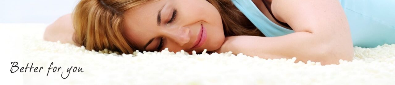 Woman peacefully resting on a soft white carpet.
