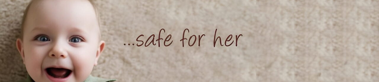 Close-up of text reading '..safe for her' on a soft beige fabric.