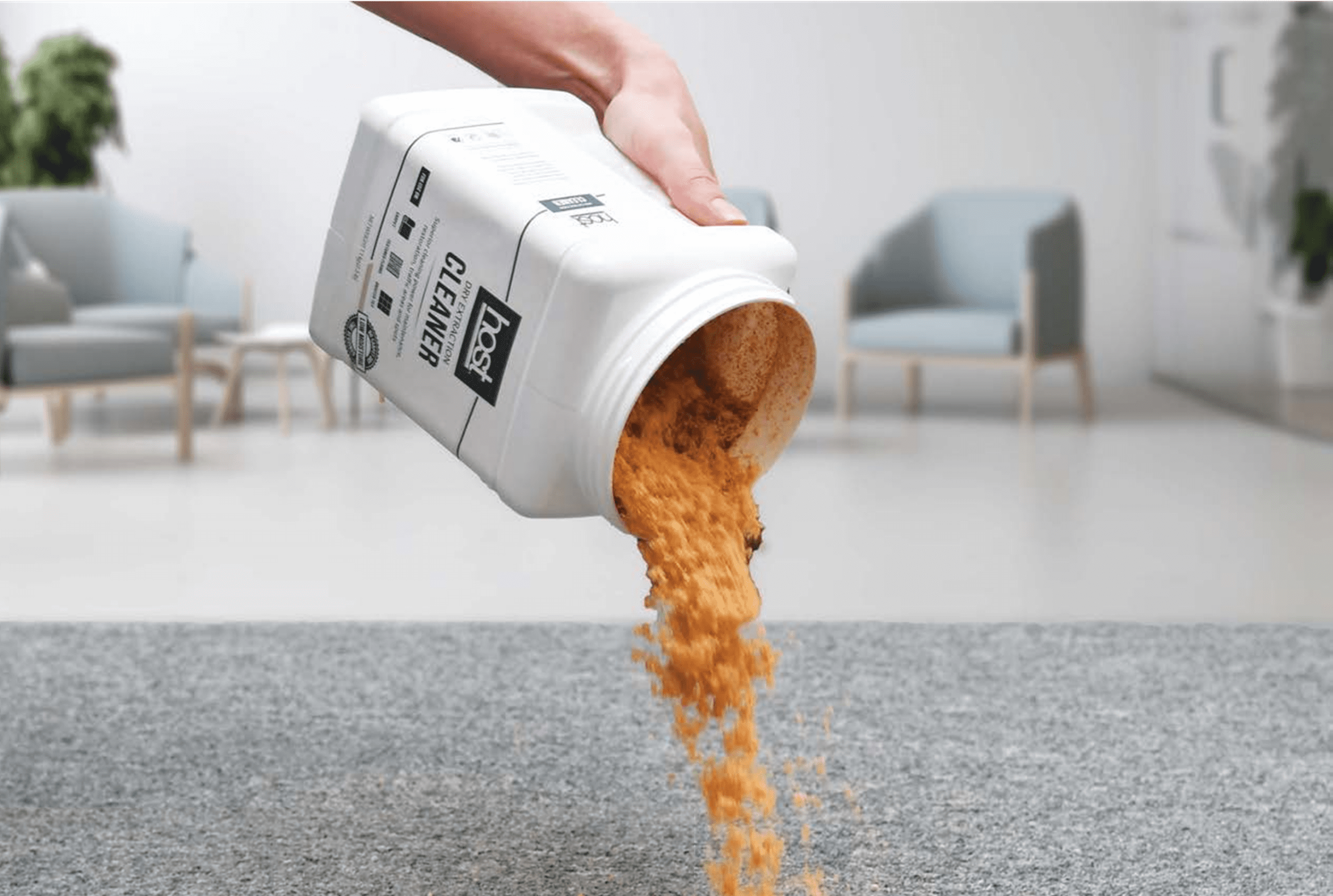 Person pouring brown sugar from a white container onto a surface.
