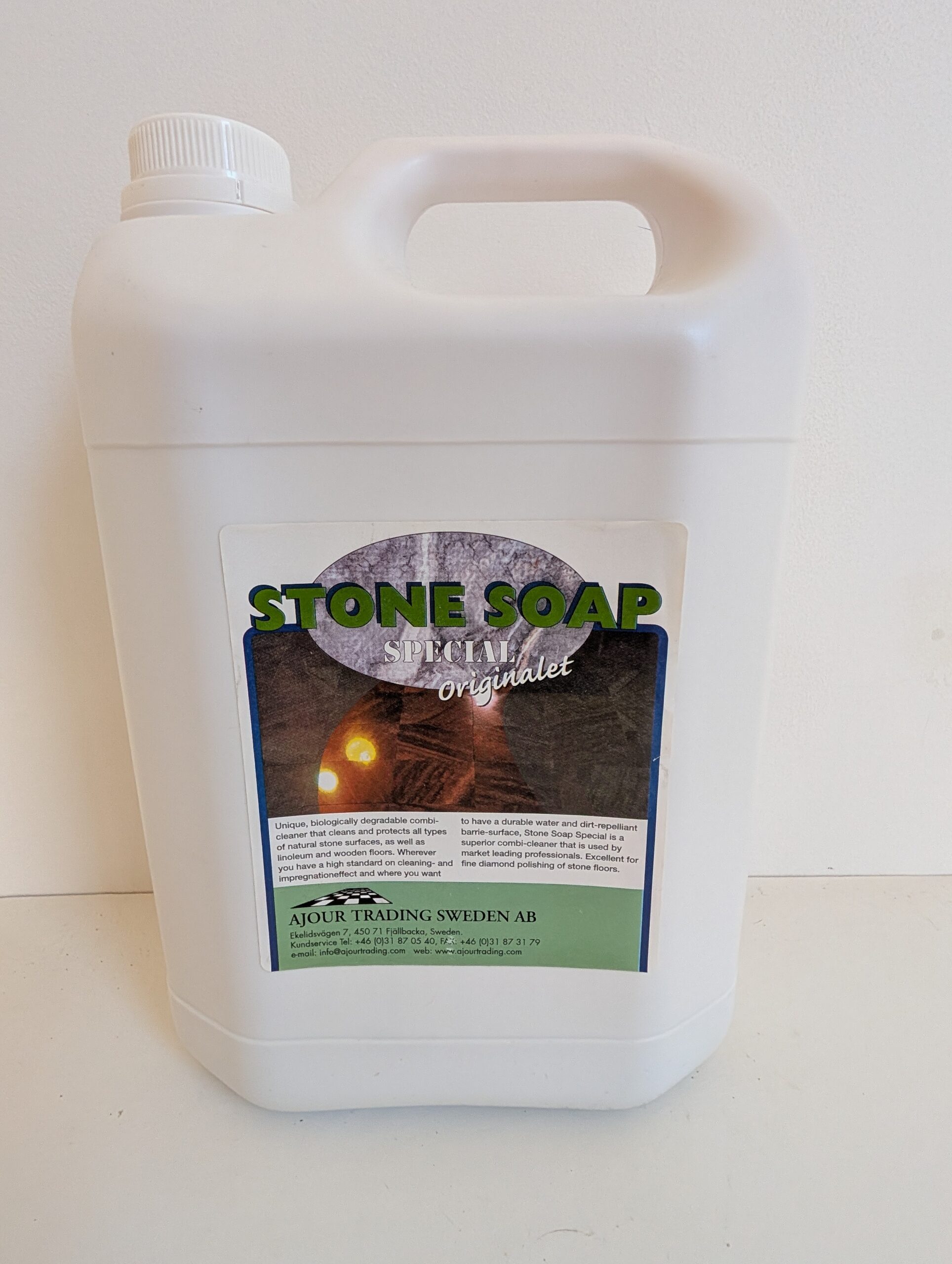 White container of stone soap with a label.